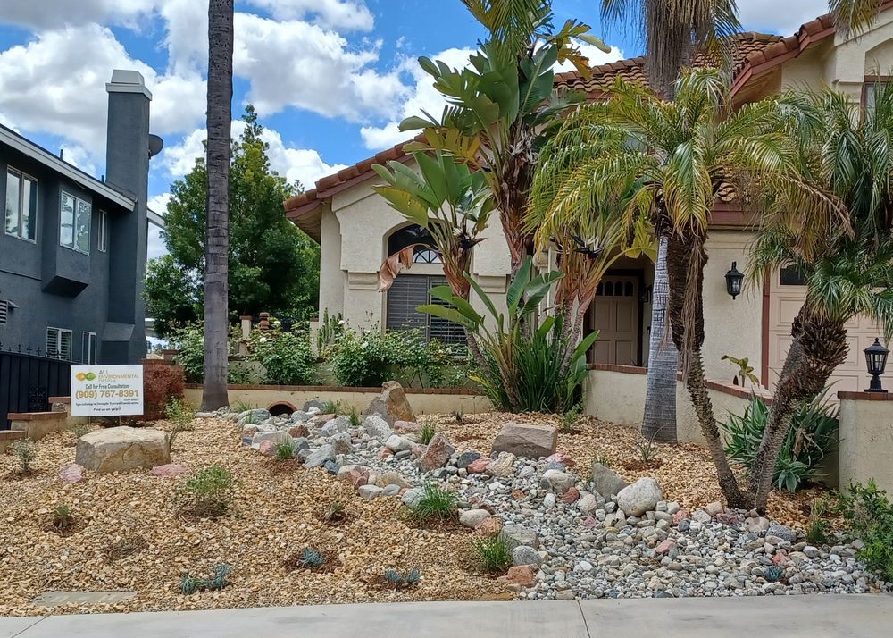Front yard we converted with a dry river bed and boulders